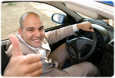 Man in car smiling because he finished his 8-hour traffic school course